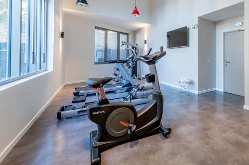 a gym with two treadmills and a treadmill at All Suites Appart Hôtel - Bordeaux Centre Gare in Bordeaux