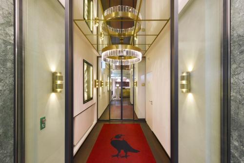 a hallway with a red carpet in a building at Hotel City Zürich Design & Lifestyle in Zürich