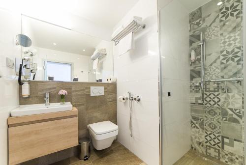 a bathroom with a toilet and a shower at Garni hotel Castle Bridge in Český Krumlov