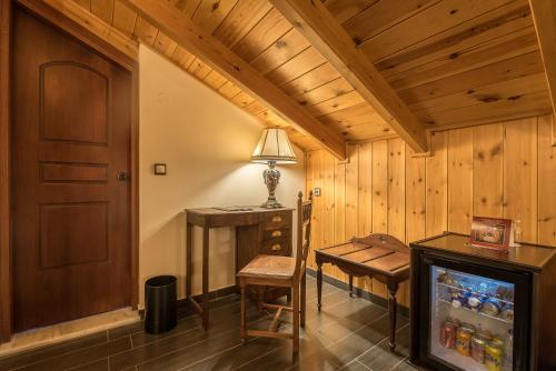 a room with a desk and a table and a lamp at Theofilos Paradise Boutique Hotel in Mytilini