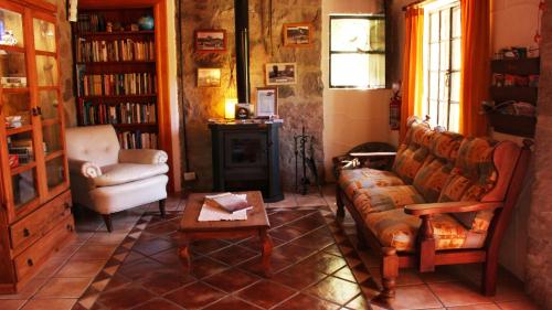 a living room with a couch and a chair at Terrazas de Cruz Chica. in La Cumbre