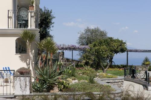 a garden with plants in front of a building at Grand Hotel Capodimonte in Sorrento