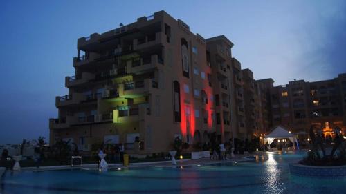 a large building with people walking in front of it at Residence Folla in Sousse