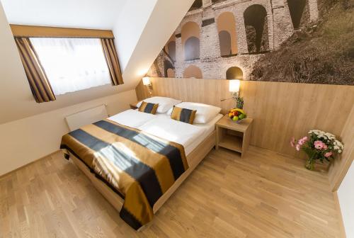 a bedroom with a bed in a room at Garni hotel Castle Bridge in Český Krumlov