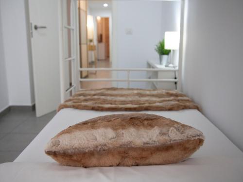 a loaf of bread sitting on top of two beds at Flats Friends Tetuan in Valencia