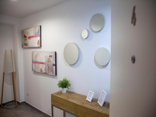 a room with several mirrors on a white wall at Flats Friends Tetuan in Valencia