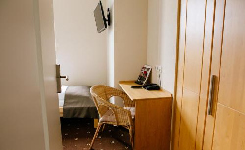 a small room with a desk and a bed at My Place in Lautzenhausen