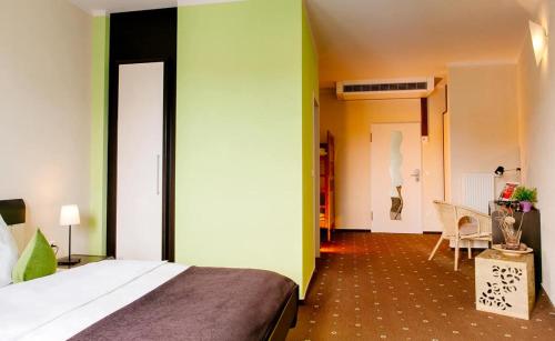 a hotel room with a bed and a dining room at My Place in Lautzenhausen
