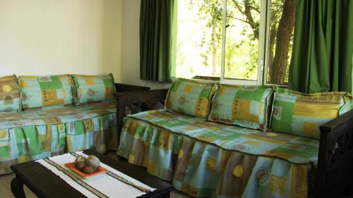 a room with two beds and a table at Terrazas de Cruz Chica. in La Cumbre