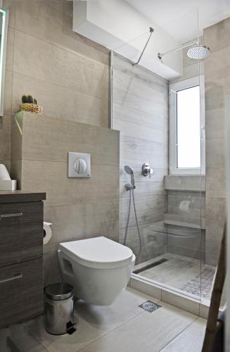 a bathroom with a toilet and a shower at The Athenians Modern Apartments in Athens