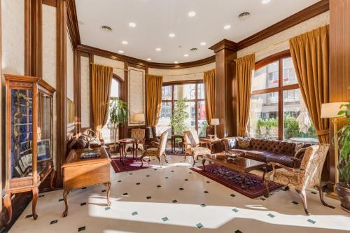 a living room with a couch and a table at Gordion Hotel - Special Class in Ankara