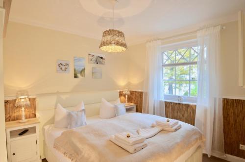 a bedroom with a bed with towels on it at Villa Strandblick 8 in Zingst