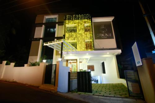 a building with lights on the front of it at night at Orionis Kannur in Kannur