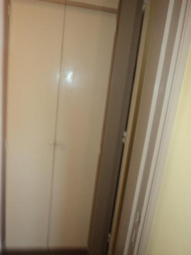 a white closet with a door in a room at Edificio Riazor n° IX in San Clemente del Tuyú