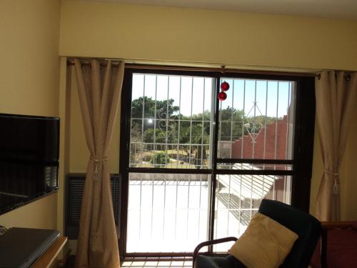 a large window with a view of a building at Edificio Riazor n° IX in San Clemente del Tuyú