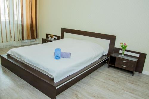a bedroom with a bed with a blue towel on it at Apartments Manghilik El 53/66 in Astana