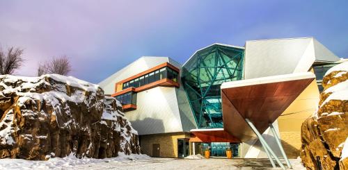 a building with snow on the ground in front of it at Sparkling Hill Resort and Spa - Adults-Only Resort in Vernon