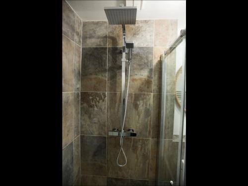a bathroom with a shower with a glass door at Gillygate Holiday Apartment in York
