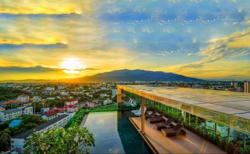 a view from the top of a building at sunset at Astra Suites Night Bazaar in Chiang Mai