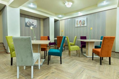 a waiting room with tables and colorful chairs at Prestige Boutique Hotel Craiova in Craiova