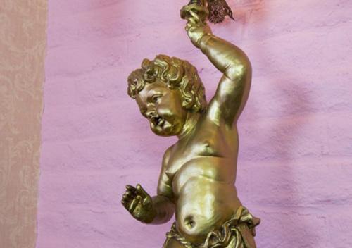 a bronze statue of a woman with her arm in the air at Madonna Inn in San Luis Obispo