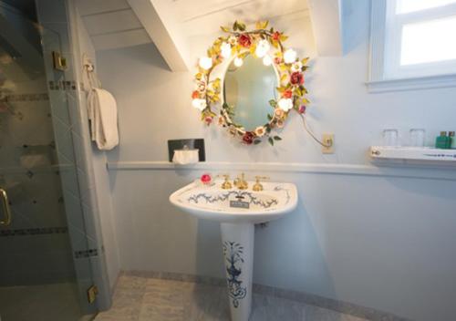 a bathroom with a sink and a mirror on the wall at Madonna Inn in San Luis Obispo