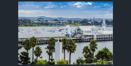 a large body of water with a large building at Waterfront (Yarra St) by Gold Star Stays in Geelong