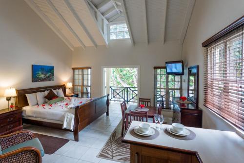 a bedroom with a bed and a living room at Blue Waters Inn in Speyside