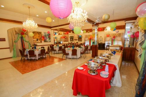 a banquet hall with tables and chandeliers and balloons at Rayon Hotel in Negril