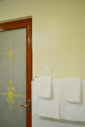 a room with a door with towels on it at Hotel Broadway Yangon in Yangon