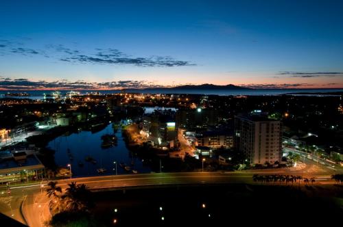 a view of a city at night at Hotel Grand Chancellor Townsville in Townsville