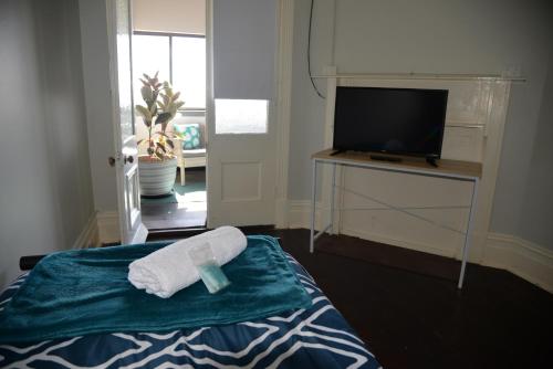 Ένα ή περισσότερα κρεβάτια σε δωμάτιο στο Geraldton Backpackers
