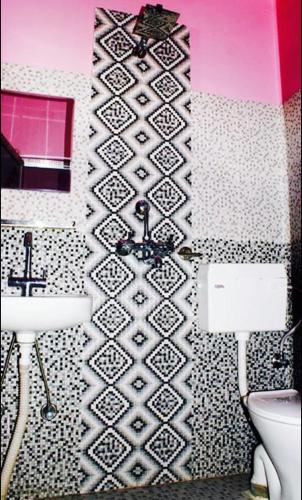 a bathroom with a sink and a toilet at Sweet Dreams Guest house in Pokhara