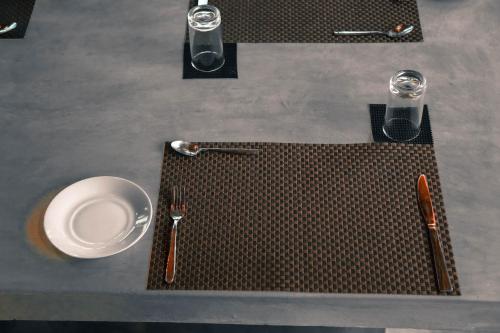 a table with a white plate and fork and knife at Sandy Edge in Kalpitiya