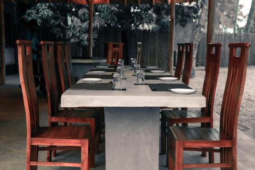 a long table with chairs and a long table at Sandy Edge in Kalpitiya