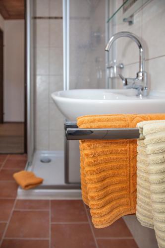 a bathroom with towels on a towel rack next to a sink at Apart Bergland in Kaunertal