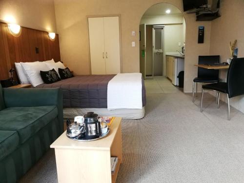 a hotel room with a bed and a couch at 299 On Devon West in New Plymouth