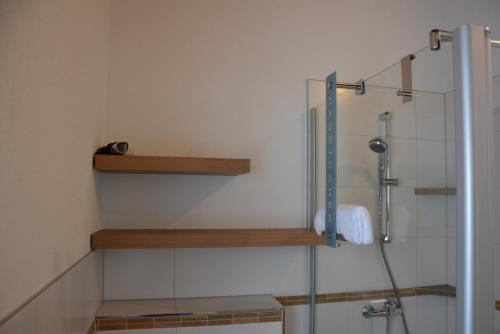 a bathroom with a shower and a glass shower stall at Ferienhaus Starenweg 8 in Tennenbronn