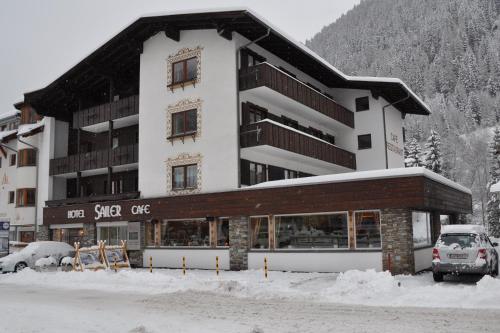 a large building with a car parked in front of it at Hotel Sailer in Sankt Anton am Arlberg