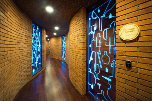 a hallway with a brick wall with blue lights at Hotel SKANZEN in Velehrad