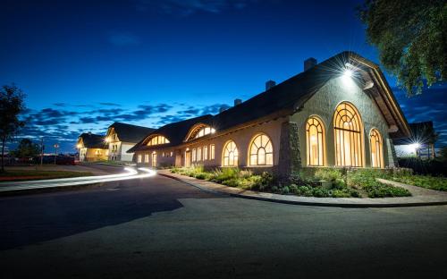a large building with lights on a street at night at Hotel SKANZEN in Velehrad