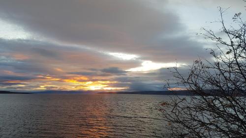 a sunset over a large body of water at Kriukot in Hólmavík