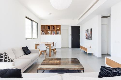 a living room with a couch and a table at Modern 2-BR in Carmel Market by HolyGuest in Tel Aviv