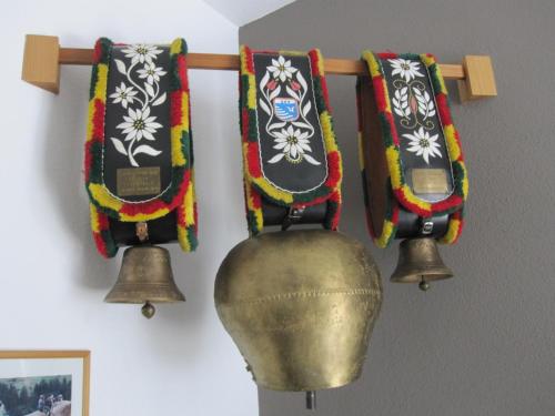 a group of bells hanging on a wall at "HAUS MELANIE" inklusive SILVRETTA PREMIUM SUMMERCARD in See