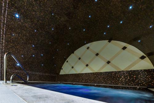 a swimming pool in a building with stars on the wall at Prónay-kastély in Alsópetény