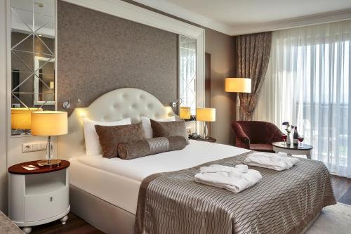 a bedroom with a large bed with two towels on it at Sunis Efes Royal Palace Resort & Spa in Özdere