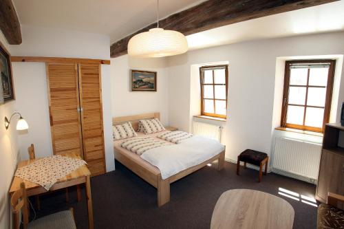 a bedroom with a bed and a table at Family in Domažlice