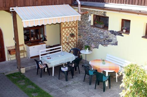 a patio with a table and chairs and a building at Family in Domažlice
