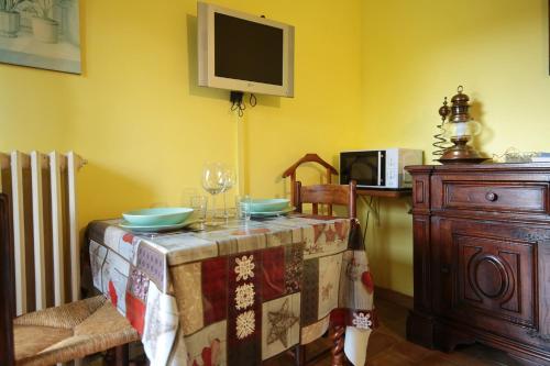 a dining room with a table and a tv on the wall at Villa Marina in Bosco