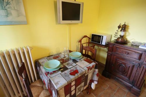 a dining room with a table and a tv and a table and chairs at Villa Marina in Bosco